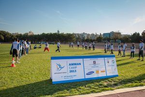 Generations For Peace volunteers playing sports on a green field at Amman Camp 2013