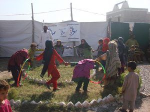 Pakistan, young girls playing with hoola hoops