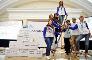 volunteers grouped around a ladder at Sochi presentation