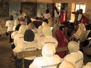 a classroom of younr veiled girls in Africa wearing Generations For Peace t-shirts