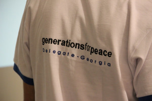 View of a t-shirt on someone's back, labeled "Generations For Peace Delegate-Georgia"