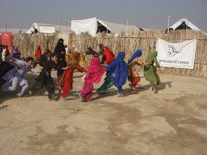 Pakistan, young girls playing a game running around in single file