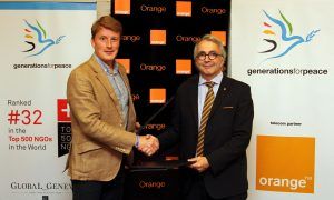 Mark Clark CEO Generations For Peace shaking hands with Mr Jean-Francois Thomas, Group CEO of Orange Jordan