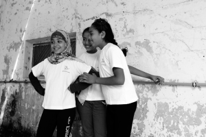 young girls smiling wearing Generations for Peace t-shirts